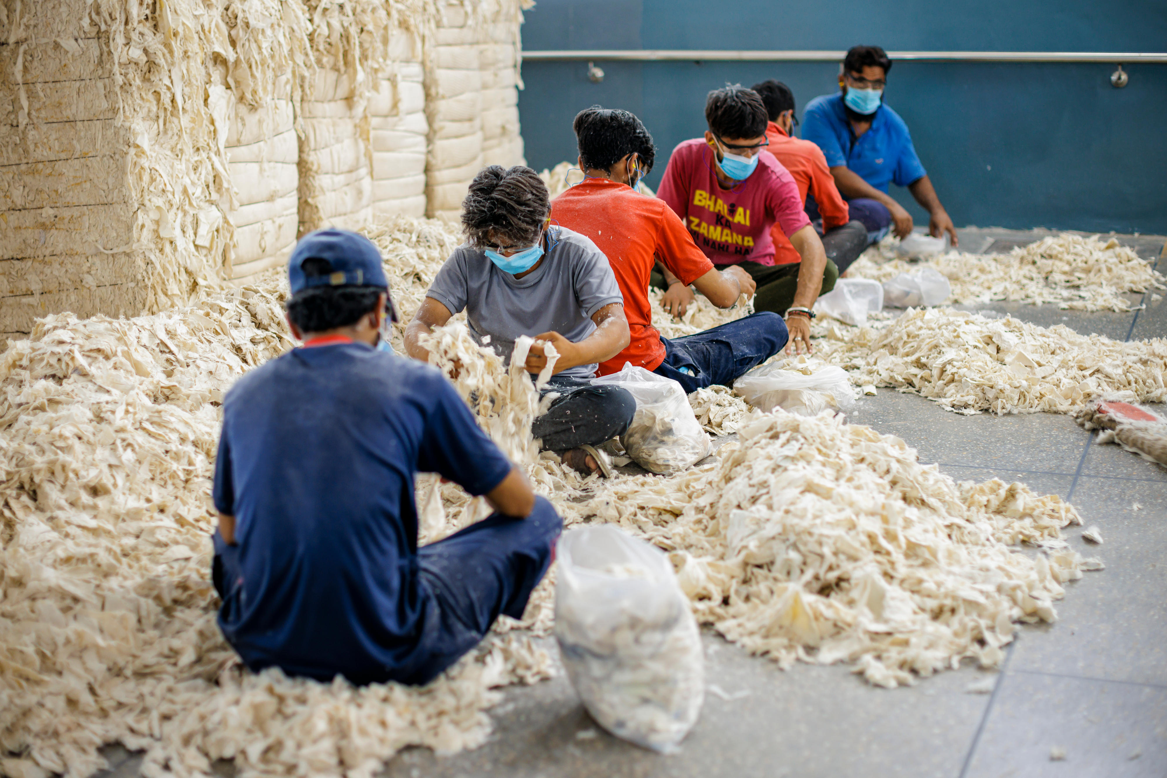 Arbeiter in der Textilfabrik Kohinoor Textile Mills Limited in Rawalpindi, Pakistan, sortieren Füllmaterial.