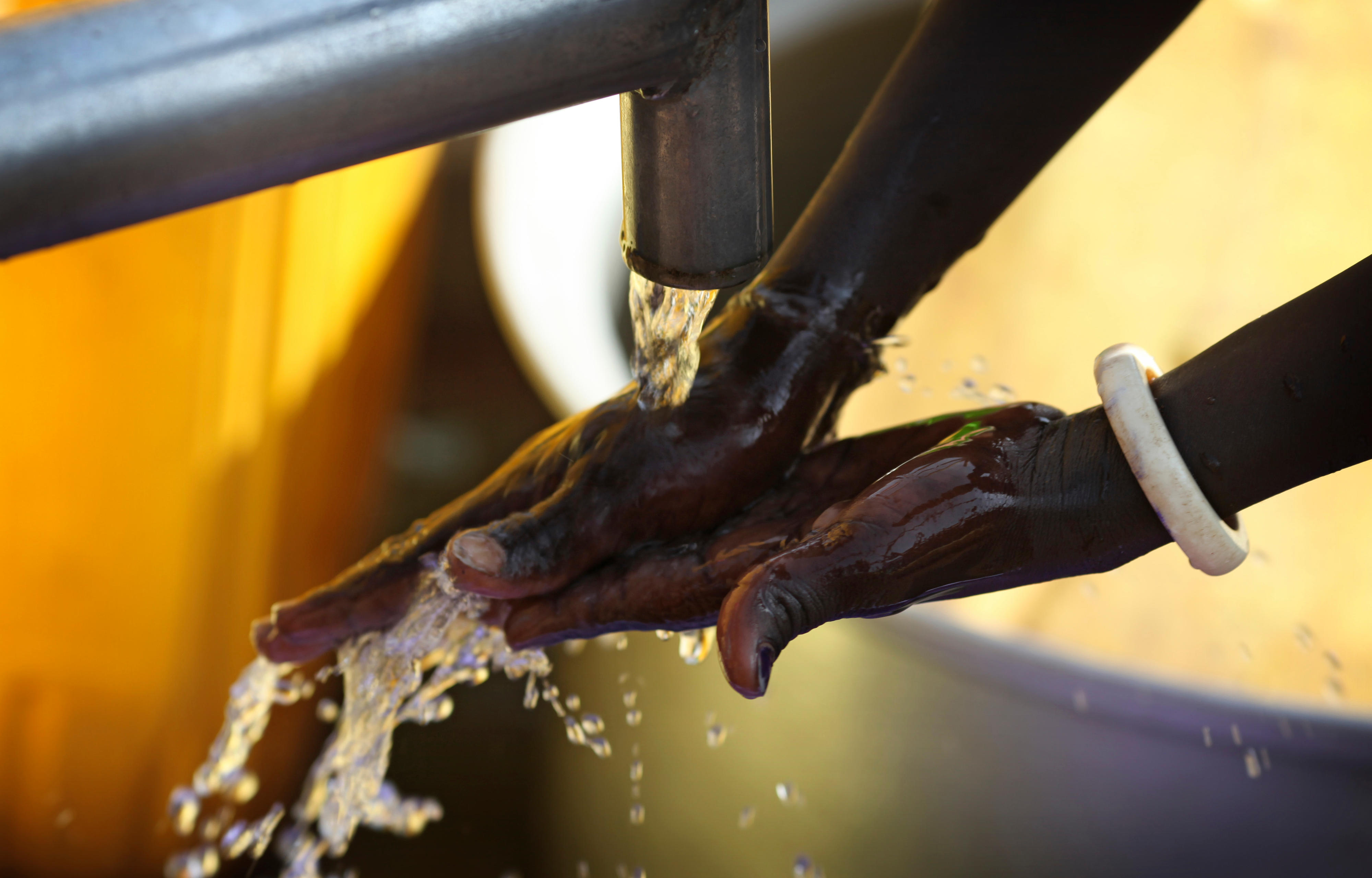 A person washes their hands at a well in Yei, South Sudan.